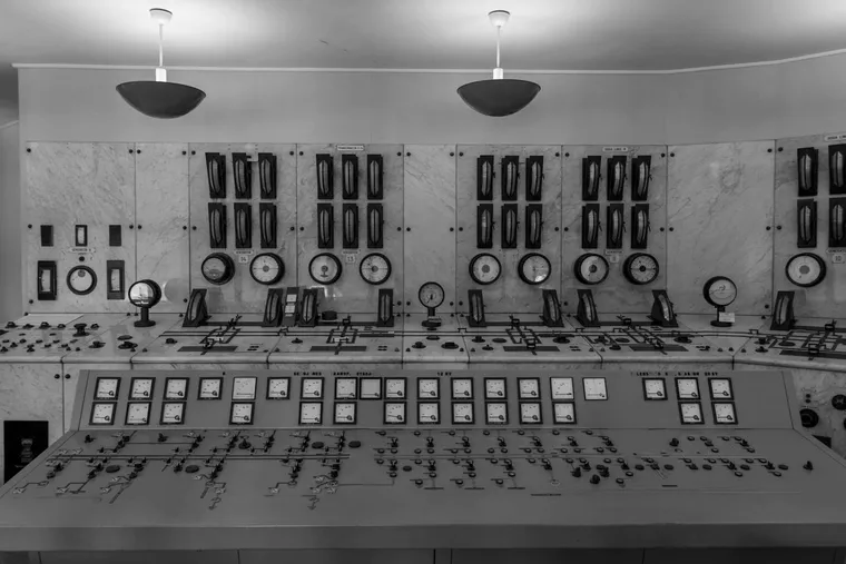 A control desk of analogue meters and switches in a generating station