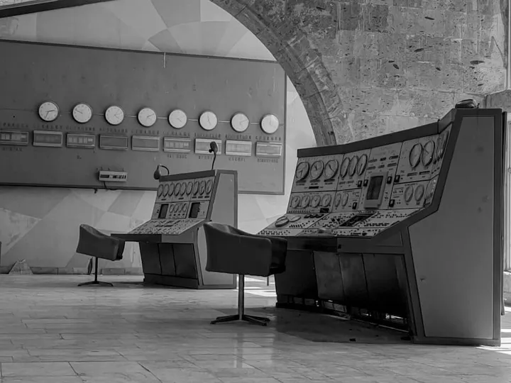A disused control room, its instrument panels still wired